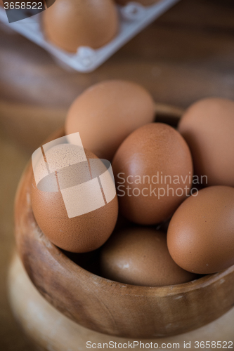 Image of Fresh eggs at wooden plate 