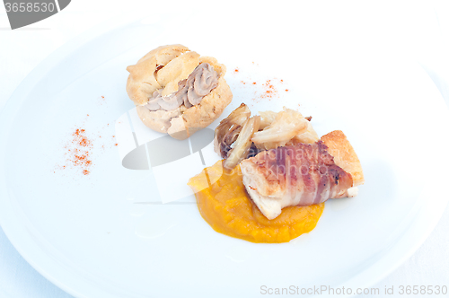 Image of Typical Italian appetizer with liver pate and bacon