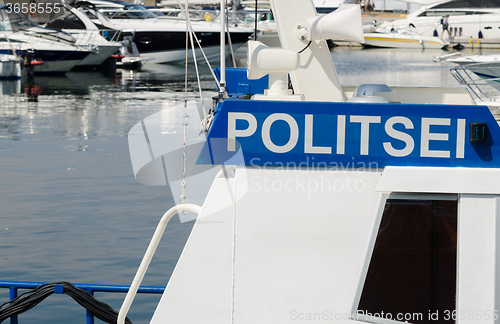 Image of Police boat on a background of yachts