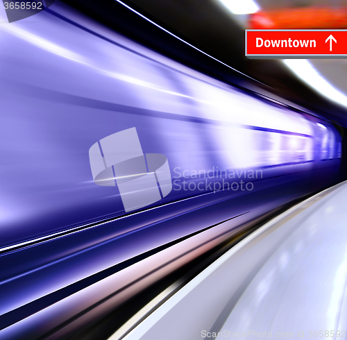 Image of train with motion blur moves in subway