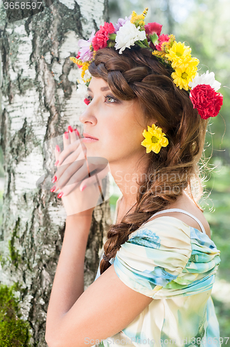 Image of Beautiful girl in wreath of flowers