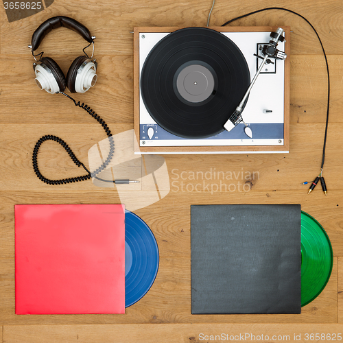 Image of Vinyl records, record player and head phones background