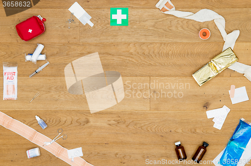 Image of Array of first aid kit objects on wooden surface with copyspace