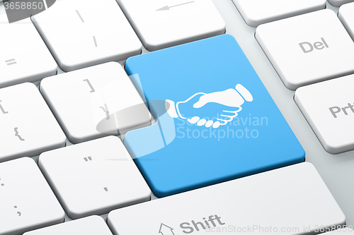 Image of Business concept: Handshake on computer keyboard background