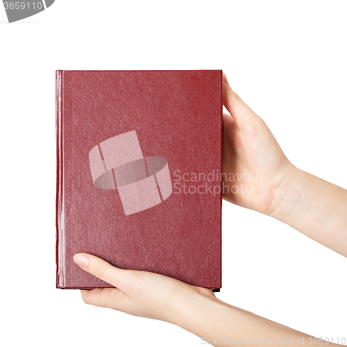 Image of woman hands holding red book