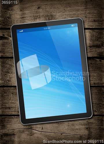 Image of Digital tablet PC on a dark wood table