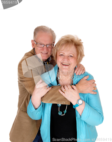 Image of Older couple hugging .