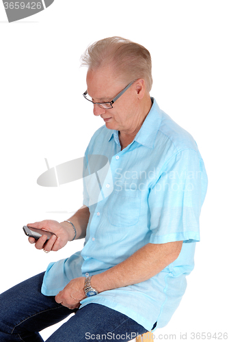 Image of Older man looking at his cell phone.