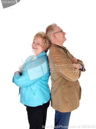 Image of Older couple standing back to back.