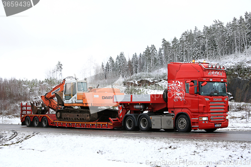 Image of Red Scania R500 Hauls Daewoo Excavator on Winter Road