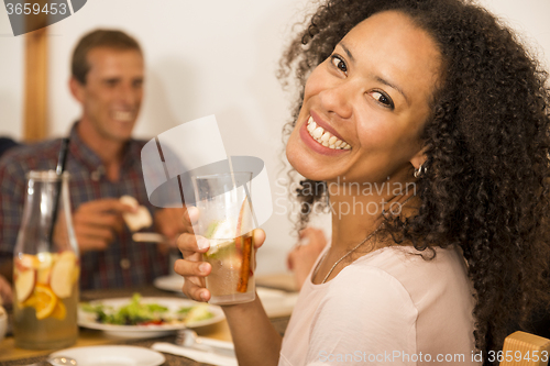 Image of Afro-american woman having a drink