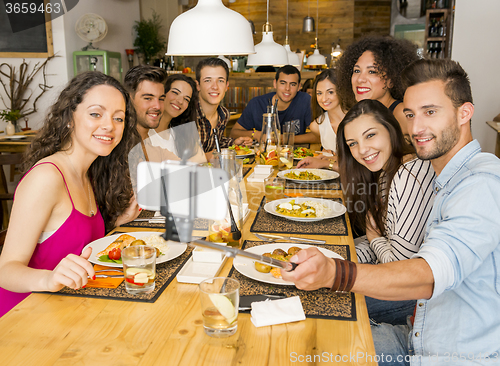 Image of Friends at the restaurant making a selfie