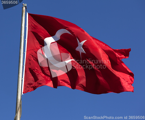 Image of Turkish flag waving in wind at sunny day