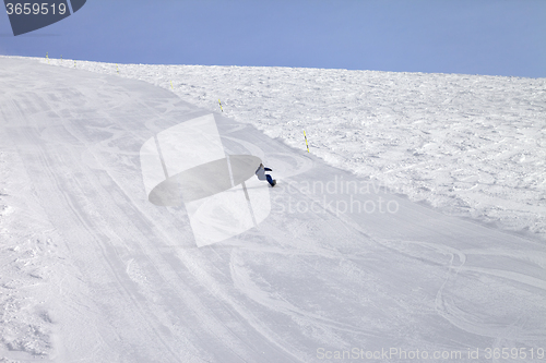 Image of Ski slope and snowboarder at sun day