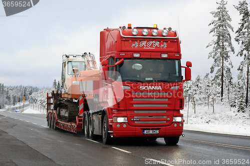 Image of Red Scania R500 Hauls Daewoo Excavator on Winter Road