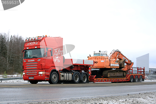 Image of Red Scania R500 Hauls Daewoo Excavator on Winter Road