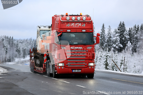 Image of Red Scania R500 Hauls Daewoo Excavator on Winter Road