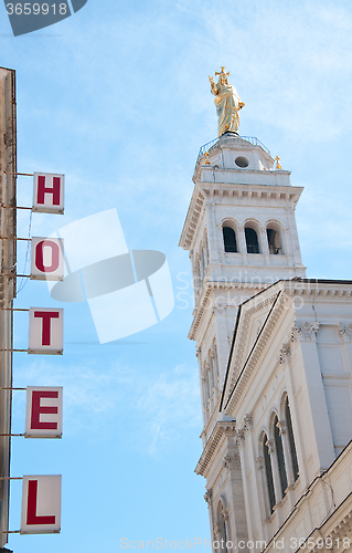 Image of 
Sign written hotels silhouetted against the sky