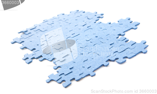 Image of Connected blue puzzle pieces isolated