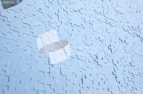 Image of Connected blue puzzle pieces isolated
