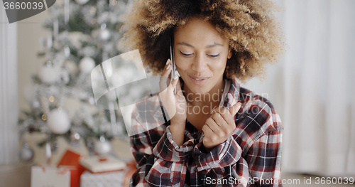 Image of Attractive African girl chatting on her mobile