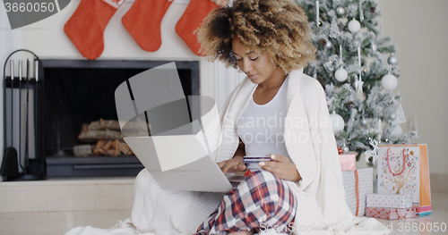 Image of Young woman enjoying Christmas Eve