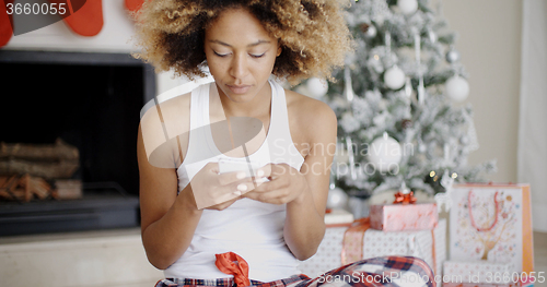 Image of Serious woman checking for Christmas messages