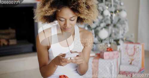 Image of Serious woman checking for Christmas messages