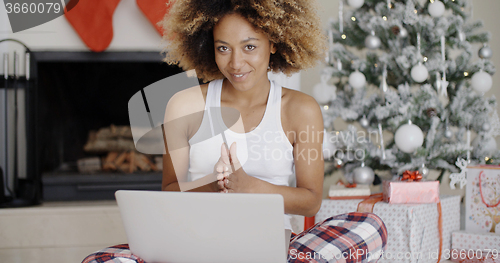 Image of Pretty young student in front of a Christmas tree