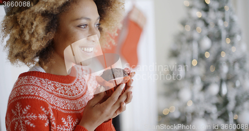 Image of Young woman savoring a Christmas cake