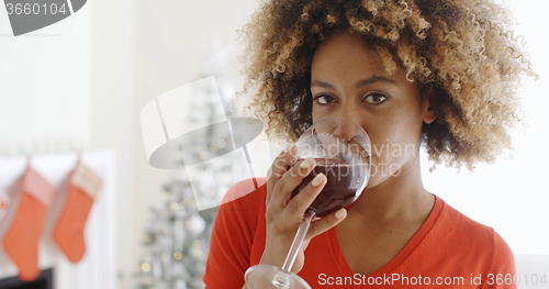 Image of Young woman offering a Christmas toast