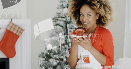 Image of Pretty young woman with a Christmas cake