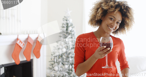 Image of Young woman offering a Christmas toast