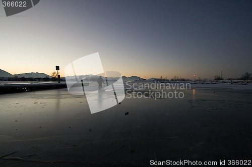 Image of Fisherman Pulling his Sled on Ice to Catch Fish