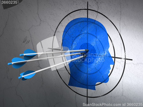 Image of Marketing concept: arrows in Head target on wall background