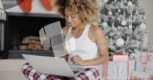 Image of Pretty young student in front of a Christmas tree