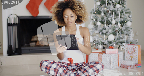 Image of Young woman attending to Xmas social media