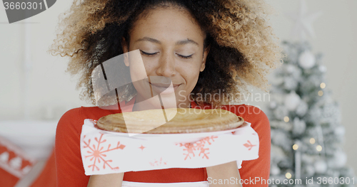 Image of Young woman with a fresh Christmas tart