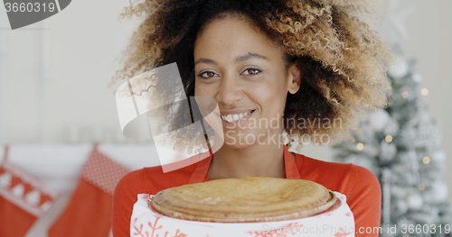 Image of Young woman with a fresh Christmas tart