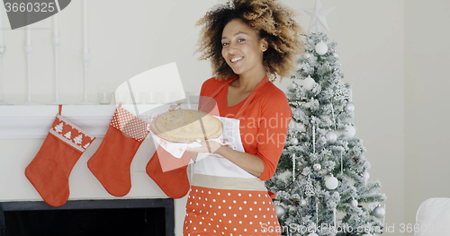 Image of Happy trendy young woman with a Christmas dessert