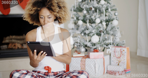 Image of Young woman attending to Xmas social media