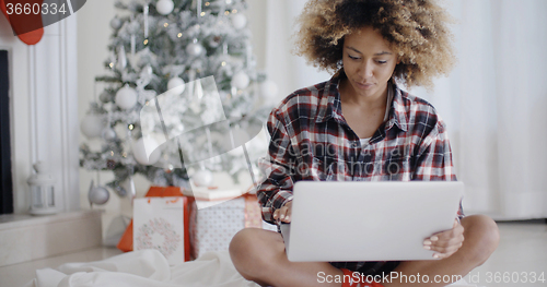 Image of Young African student working on her laptop