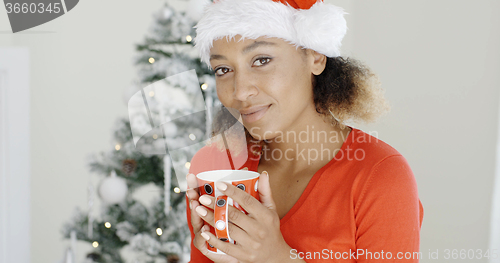 Image of Young girl enjoying coffee on Christmas Day