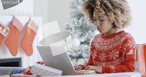 Image of Trendy young woman working on a laptop