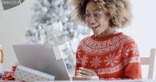 Image of Excited happy young woman at Christmas