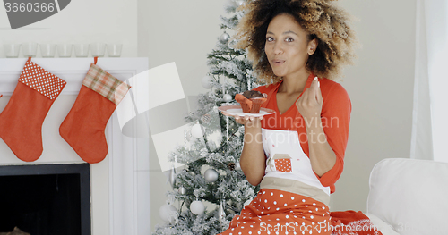 Image of Happy young African woman celebrating Christmas