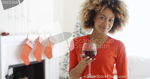 Image of Young woman offering a Christmas toast