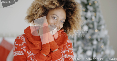 Image of Smiling happy young woman in a Christmas outfit