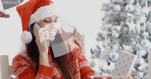 Image of Young woman making a Christmas greeting call