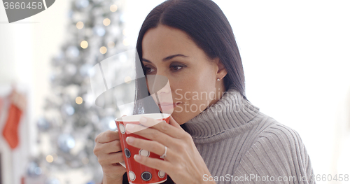 Image of Woman enjoying a cup of Christmas coffee